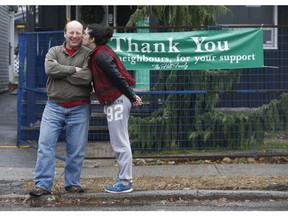 Rachel Hill gives a kiss to neighbour Trevor Wilkins in front of her burned-out family home on Gould Street. The house caught fire on Nov.  10 and neighbours and friends have pitched in to help the Hills.