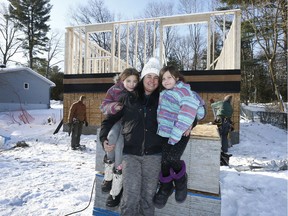 Karalee Shaw Plourde and her daughters Kiersten and Kaylee pose for a photo in front of their new house in Constance Bay Ontario Thursday Dec 28, 2017.