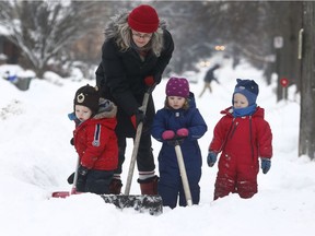 Ilona Peltz gets some help from Sam, Magnus and Maddie shovelling her walkway on Sunnyside Avenue in Ottawa Tuesday Dec 19, 2017.   Tony Caldwell