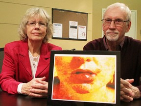 Margaret Keith and Jim Brophy who, with Michael Hurley of the Ontario Council of Hospital Unions, conducted a study of violence against health-care workers, pose with a photo of a battered worker.