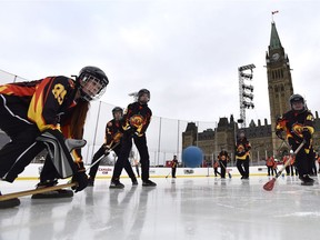 Members of the Kitigan Zibi girls Broomball team scrimmage before the official inauguration of the Canada 150 Rink on Parliament Hill in Ottawa on Thursday, Dec. 7, 2017.