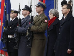 British Prime Minister Theresa May, second right, is welcomed to Poland by Polish Prime Minister Mateusz Morawiecki in Warsaw on Dec. 21. May's visit to the Polish capital came at a politically turbulent time for both countries, as Britain prepares to leave the European Union and Poland finds itself in a escalating standoff with the EU over a bitterly criticized overhaul of its judicial system.