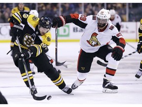 Boston Bruins' left wing Brad Marchand, left, breaks towards the net as Ottawa Senators' defenceman Johnny Oduya (29) stays close in Wednesday's game, which the Senators lost.