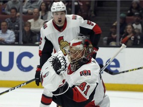 Ottawa Senators goalie Craig Anderson, below, catches the puck with defenseman Cody Ceci, above, watching against the Anaheim Ducks during the second period of an NHL hockey game in Anaheim on Wednesday.