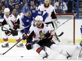 Tampa Bay Lightning center Steven Stamkos (91) steals the puck from Ottawa Senators center Derick Brassard (19) during the first period of an NHL hockey game Thursday, Dec. 21, 2017, in Tampa, Fla.