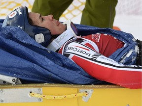 Marie-Michele Gagnon of Canada is placed on a sled after wiping out during a training run on Thursday at Lake Louise, Alta.