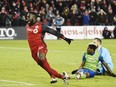 Toronto FC forward Jozy Altidore celebrates after scoring against Seattle Sounders goalkeeper Stefan Frei, right, as defender Joevin Jones looks on during the second half of the MLS Cup final in Toronto on Saturday, Dec. 9, 2017.