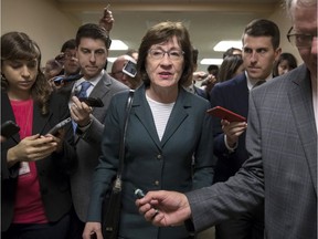 In this Nov. 30, 2017, file photo, with reporters looking for updates, Sen. Susan Collins, R-Maine, and other senators rush to the chamber to vote on amendments as the Republican leadership works to craft their sweeping tax bill in Washington. Collins said she is confident President Donald Trump and Senate Majority Leader Mitch McConnell will ensure passage of two bills aimed at shoring up the insurance markets, a demand she made before supporting the Republican tax overhaul.