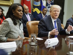 In this Feb. 1, 2017, file photo, President Donald Trump speaks during a meeting on African American History Month in the Roosevelt Room of the White House in Washington. From left are, Omarosa Manigault, Trump, and then-Housing and Urban Development Secretary-designate Ben Carson. Omarosa Manigault Newman -- the former "Apprentice" contestant who became one of Trump's most prominent African -American supporters -- has resigned from the White House.