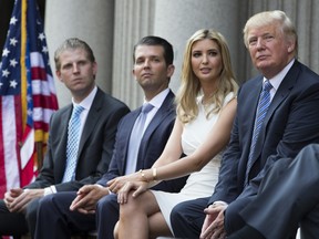 Files: Donald Trump, right, sits with, from left, Eric Trump, Donald Trump Jr., and Ivanka Trump during a ground breaking ceremony for the Trump International Hotel on the site of the Old Post Office, on Wednesday, July 23, 2014, in Washington.
