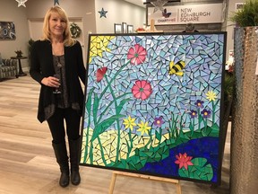 Barbara Verner stands beside a piece of artwork from her series 'The Lilypond.'