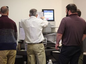 Officials will use a high-speed machine on to recount results from the 94th District House of Delegates race at City Center in Newport News, Va. on Tuesday, Dec. 19, 2017. Incumbent Republican Del. David Yancey won by 10 votes. Democratic challenger Shelly Simonds requested the recount.