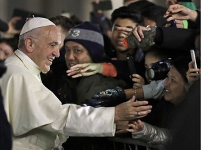 Pope Francis stops to greet the faithful after praying in front of the nativity scene after celebrating a new year's eve vespers Mass in St. Peter's Basilica at the Vatican on Sunday.