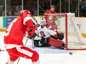 67's goalie Olivier Tremblay tracks the puck as the Greyhounds buzz his net in the Soo's 4-0 win on Sunday.