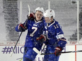 U.S. forward Brady Tkachuk, left, celebrates his goal with forward Casey Mittelstadt during the third period against Canada on Friday, Dec. 29, 2017.