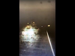 Screen capture of dashcam video of truck travelling wrong way on Highway 401.