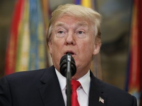 In this Dec. 12, 2017, photo, President Donald Trump speaks before signing the National Defense Authorization Act for Fiscal Year 2018, in the Roosevelt Room of the White House in Washington. An FBI agent removed from special counsel Robert Mueller's investigative team over politically charged text messages at one point referred to Trump, then the Republican presidential candidate, as an "idiot." The Associated Press reviewed dozens of text messages between Peter Strzok, an FBI counterintelligence agent, and Lisa Page, an FBI lawyer who was detailed to Mueller's team earlier this year. The Justice Department turned the messages over to Congress on Dec. 12.