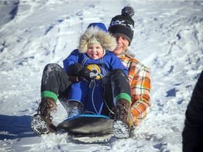 Allan Alguire and two-year-old Isabel Alguire were all smiles when they hit the hill at Westboro Beach.