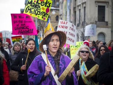 Ogimaakwewak Singers, including Marissa Mills, lead the march off of Parliament Hill and down Wellington Street with traditional drumming and singing.