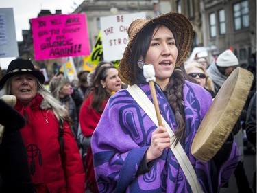 Ogimaakwewak Singers, including Marissa Mills, lead the march off of Parliament Hill and down Wellington Street with traditional drumming and singing.