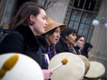 Ogimaakwewak Singers, including Marissa Mills (second from left), lead the march off of Parliament Hill and down Wellington Street with traditional drumming and singing.