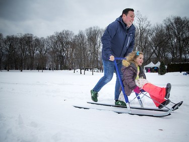 Four-and-a-half-year-old Zoe Zufelt gets a push from her friend, Ben, as they tried out a kicksled, which the Republic of Finland brought to the event.