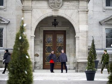 Pte. Kelvin Jiang, left, and Guardsman Justin Turcotte stand in the arch of the front door of Rideau Hall.