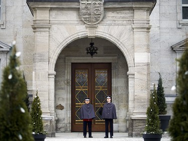 Pte. Kelvin Jiang, left, and Guardsman Justin Turcotte stand in the arch of the front door of Rideau Hall.