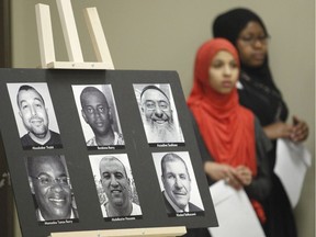 Children stand next to photos of the victims of the Quebec City mosque attack at a multifaith prayer and remembrance event in Kanata, Sunday, January 28, 2018, on the first anniversary of the attack   (Patrick Doyle)  ORG XMIT: 0128 mosque remembrance 02