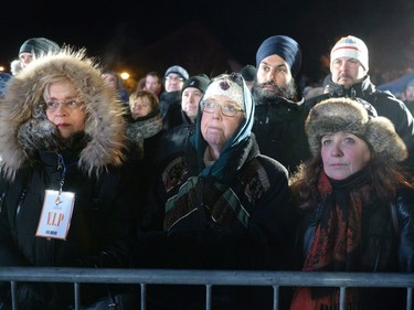 Green Party Leader Elizabeth May, front centre, and NDP Leader Jagmeet Singh, rear centre, attend a vigil to commemorate the one-year anniversary of the Quebec City mosque shooting, in Quebec City, Monday, Jan. 29, 2018.