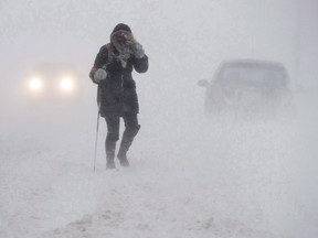 A pedestrian walks down Brunswick Street near Citadel Hill in Halifax as a major winter storm blasts the Maritimes on Monday, Feb. 13, 2017.