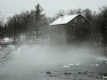 11:15 am at Watson's Mill in Manotick, where the warmer air mixed with the cooler water created a fog all the way along the canal to downtown. Ottawa was hit with some weird weather Friday, with balmy temperatures and rainy weather earlier in the day, giving way to cold, wind and snow later in the day. Julie Oliver/Postmedia