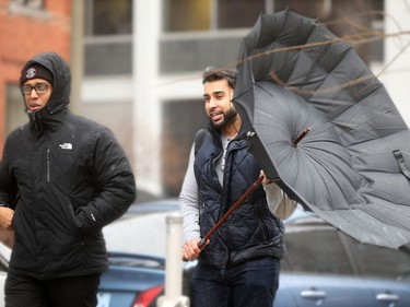 1:25 pm. outside City Hall, the wind picks up and renders umbrellas useless. Ottawa was hit with some weird weather Friday, with balmy temperatures and rainy weather earlier in the day, giving way to cold, wind and snow later in the day. Julie Oliver/Postmedia