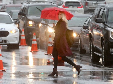 12: 28 p.m. The intersection at Elgin and Laurier was slick with rain as people made their way around downtown during lunch hour.  Ottawa was hit with some weird weather Friday, with balmy temperatures and rainy weather earlier in the day, giving way to cold, wind and snow later in the day. Julie Oliver/Postmedia