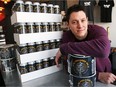 Adam Newlands is seen with Dr. Feel Good IPA cans and labels.  Stalwart Brewery's Dr. Feelgood IPA was pulled from LCBO shelves for the medical imagery on its logo, which the LCBO claims could mislead consumers about its medical properties.