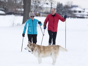 Ski Heritage East members Alexa Brewer (L) and Ian Gadbois ski on non-groomed snow with dog "Meeka". The group has secured funding from the city to pay for professional groomers to maintain 8 kilometres of trail along the Ottawa River between Green's Creek and Trim Road. January 3,2018.