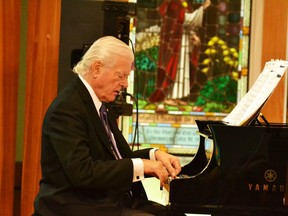 Former senator Tommy Banks on piano.