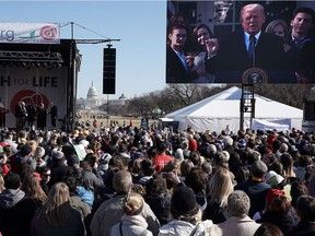 WASHINGTON, DC - JANUARY 19:  Pro-life activists watch U.S. President Donald Trump giving remarks from the Rose Garden of the White House on a jumbotron during a rally at the National Mall prior to the 2018 March for Life January 19, 2018 in Washington, DC. Activists gathered in the nation's capital for the annual event to protest the anniversary of the Supreme Court Roe v. Wade ruling that legalized abortion in 1973.