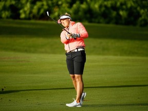 Brooke Henderson of Smiths Falls hits her second shot on the first hole during the second round of the Pure Silk Bahamas LPGA Classic on Friday. Henderson bogeyed the hole to fall back into a tie for the lead, but it was the only hole she completed before play was suspended for the day because of high winds.