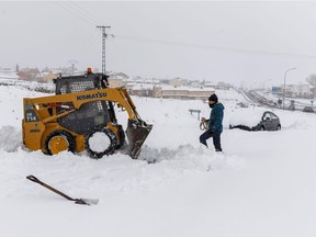 A small bulldozer clears a road at the entrance of Villacastin, Segovia province, after this winter's first heavy snowfall on January 7, 2018. The Spanish army's emergency unit UME said it had sent two companies of specialist soldiers and 95 vehicles to free hundreds of cars stranded on the AP6 highway linking Madrid and the northwestern city of Segovia.