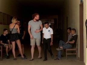 This photo taken on January 27, 2018 shows a group of foreigners outside a courtroom in Siem Reap province, some who were reportedly arrested on January 25 for allegedly "singing and dancing pornographically". Cambodia has arrested 10 foreigners, six British nationals, two Canadians, one New Zealander and one defendant whose citizenship was not identified, police said on January 28, as the kingdom cracks down on racy behaviour at popular tourist sites.