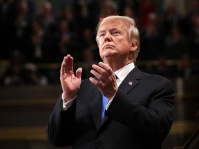 US President Donald  Trump claps during the State of the Union address in the chamber of the US House of Representatives in Washington, DC, on January 30, 2018.