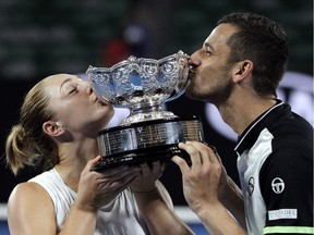 Canada's Gabriela Dabrowski, left, and Croatia's Mate Pavic kiss their trophy after defeating Hungary's Timea Babos and India's Rohan Bopanna in the mixed doubles final at the Australian Open tennis championships in Melbourne, Australia, Sunday, Jan. 28, 2018.