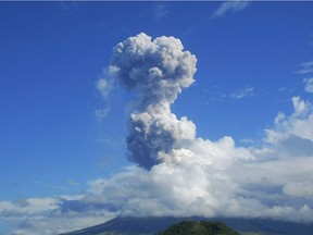 Files: A cloud of volcanic ash shoots up to the sky as Mayon volcano, one of the Philippines' most active volcanoes, erupts after daybreak, viewed from Legazpi in Albay province in the central Philippines, Tuesday, May 7, 2013. At least five climbers were killed and more than a dozen others are trapped near the crater in its first eruption in three years, officials said. Rescue teams and helicopters were sent to Mayon volcano to bring out the dead.