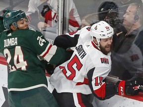 Ottawa Senators' Zack Smith, right, tries to break free from Minnesota Wild's Matt Dumba in the first period of an NHL hockey game Monday, Jan. 22, 2018, in St. Paul, Minn.The Associated Press