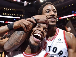 The Raptors' Kyle Lowry, left, and DeMar DeRozan, who finished with a career-best 52 points, celebrate after defeating the Bucks in Toronto on Monday night.
