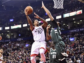 Raptors guard DeMar DeRozan (10) shoots over Bucks forward John Henson (31) during the first half of Monday's game in Toronto. DeRozan finished the night with a career-best and team-record total of 52 points.