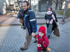 oshua and Caitlan Boyle and their three children walk on Elgin Street on Nov. 22.