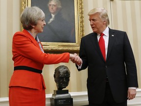 In this Jan. 27, 2017 file photo of US President Donald Trump as he shakes hands with British Prime Minister Theresa May in the Oval Office of the White House in Washington.