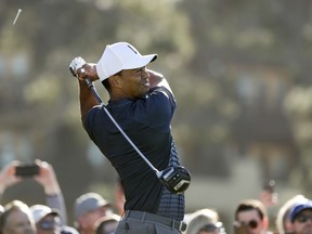 Tiger Woods watches his tee shot on the 10th hole hole of the North Course at Torrey Pines Golf Course during the second round of the Farmers Insurance Open golf tournament Friday, Jan. 26, 2018, in San Diego.